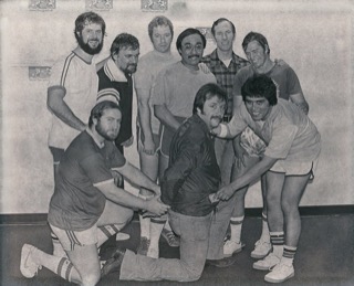 Photo from the Woodland Daily Democrat, taken around 1980-1981. Racquetball players from the county-wide team pretend to take money from a Woodland police officer after the county team won the tournament.