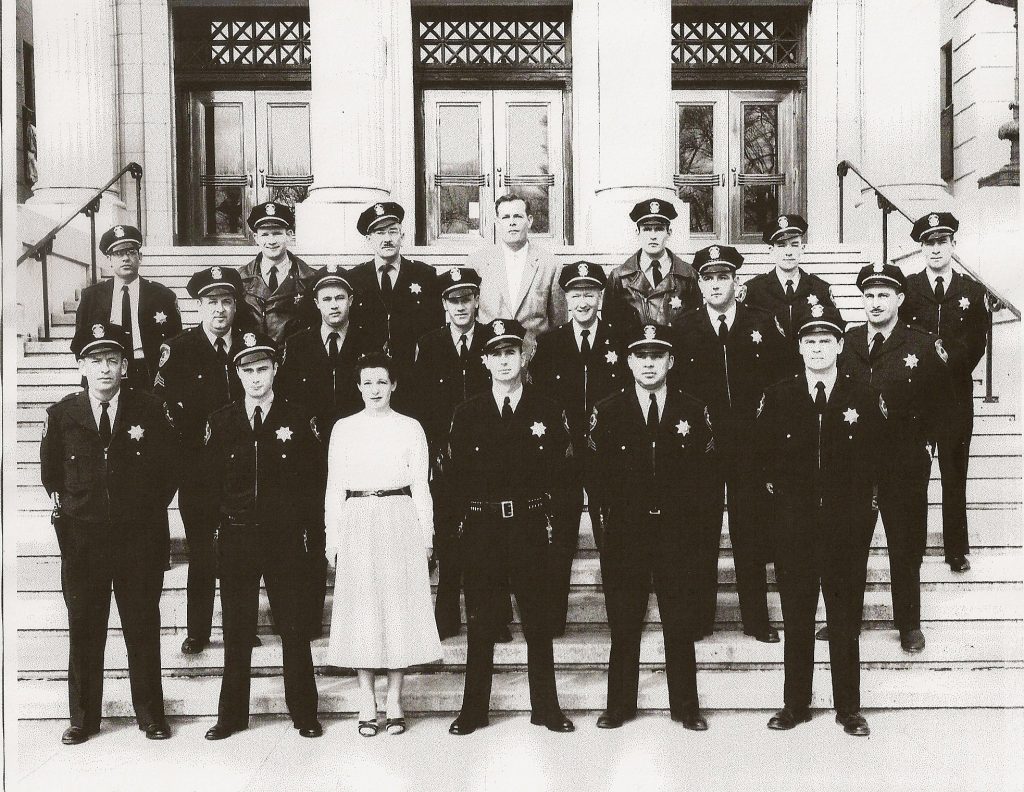 Yolo County Sheriff deputies lined up for picture. One wife included in picture. Date of photo unknown.