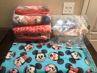 Stack of fleece blankets donated to Project Linus by The 100 Club.